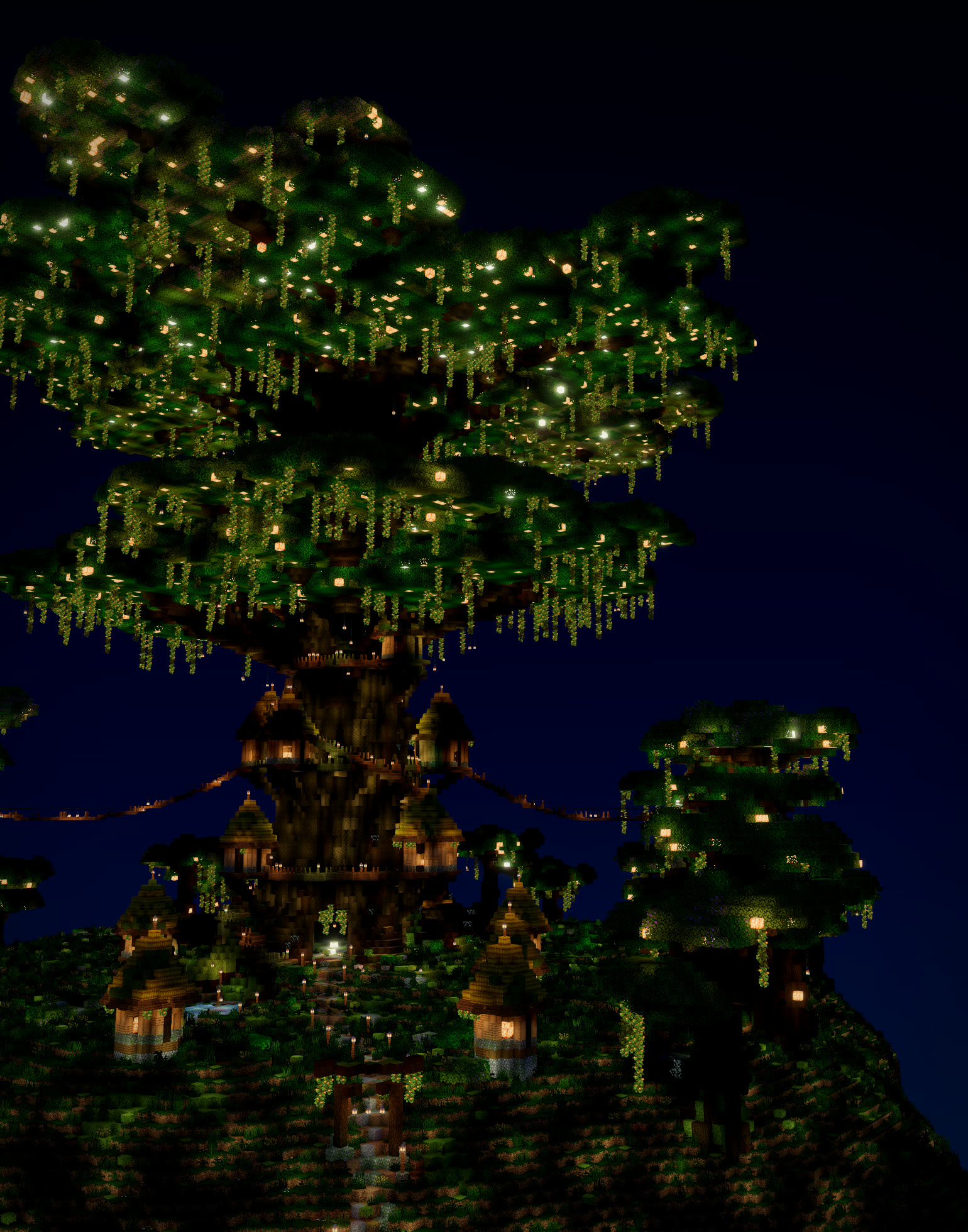 Night shader render of a colossal glowing tree with a lantern-lit village of thatched huts around its trunk, built with Moxel Worlds